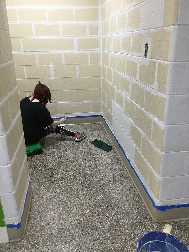 Students volunteering to help paint