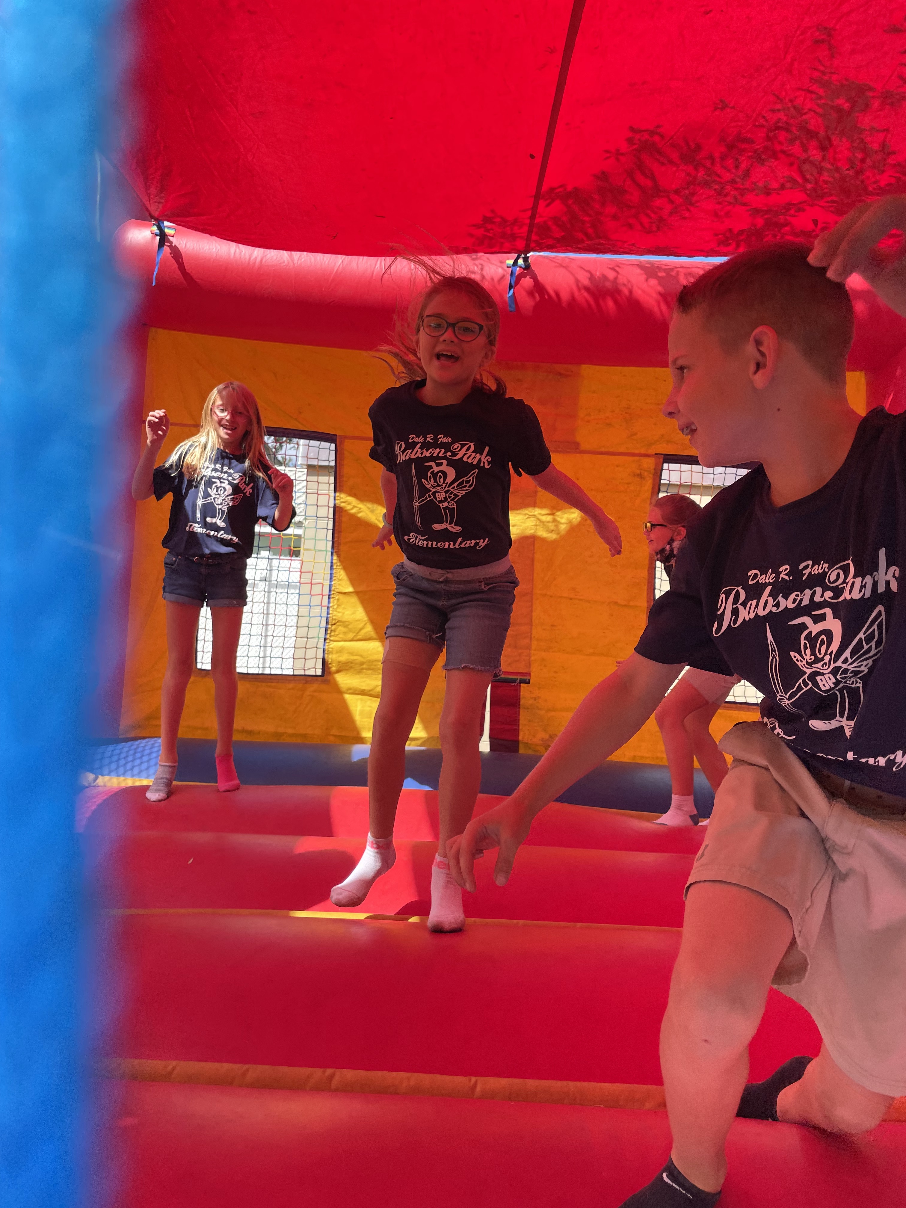 Students playing in the jump house