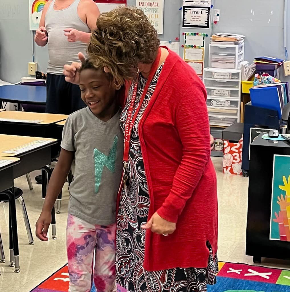Student greets teacher at open house event