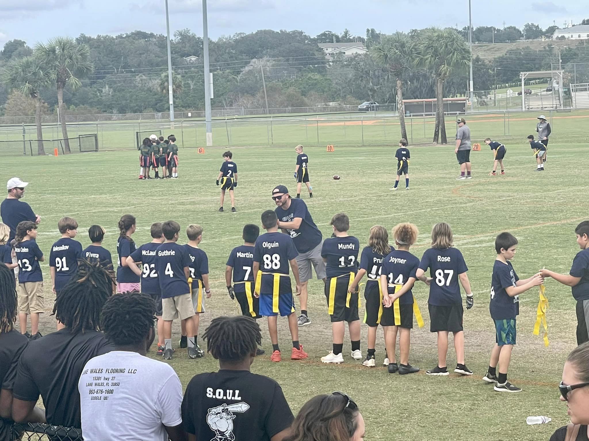 Gnat football players watching the game from the sidelines.