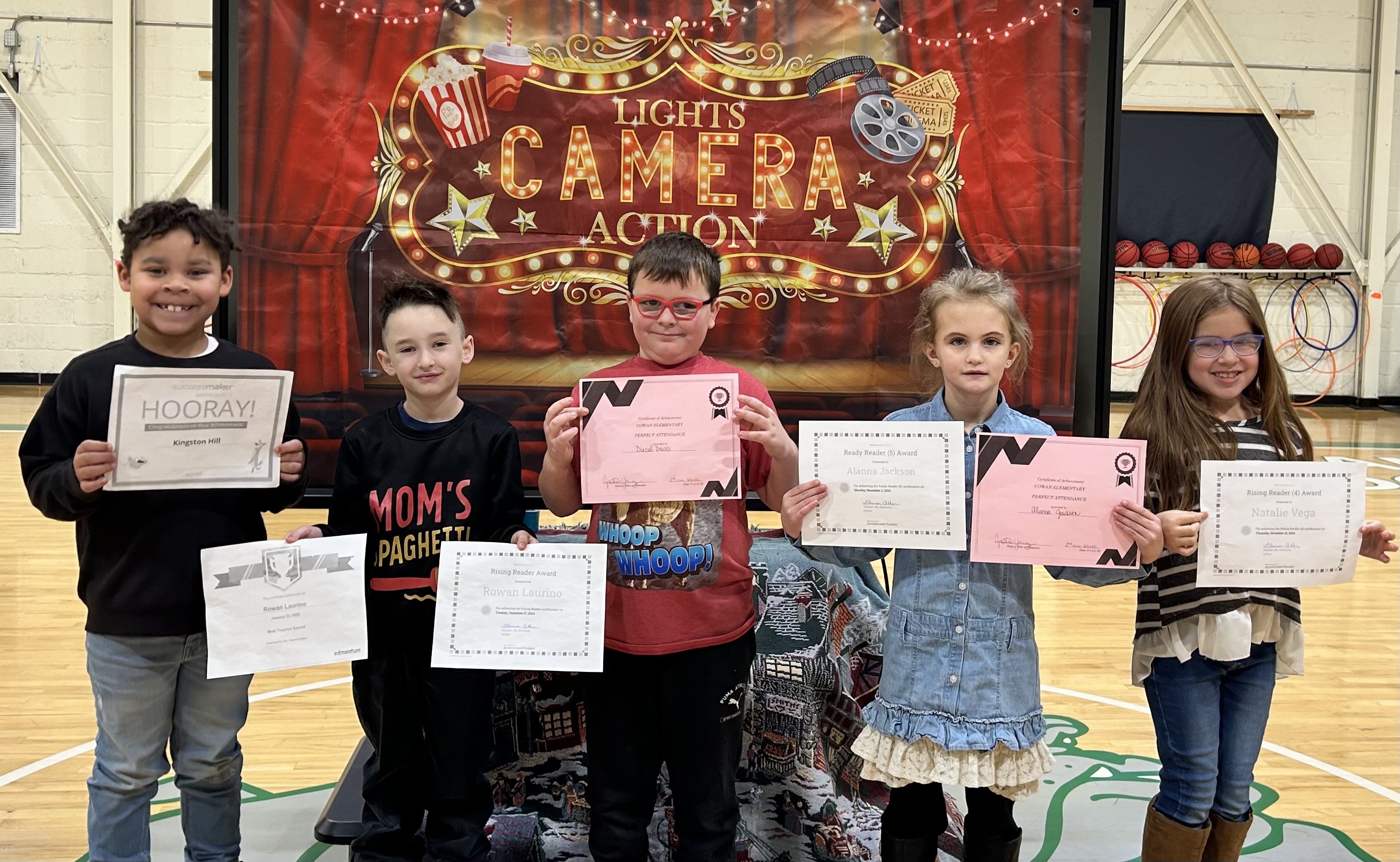 students holding up their awards