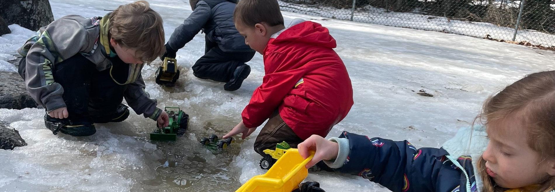 Preschool Students play in the slushy snow