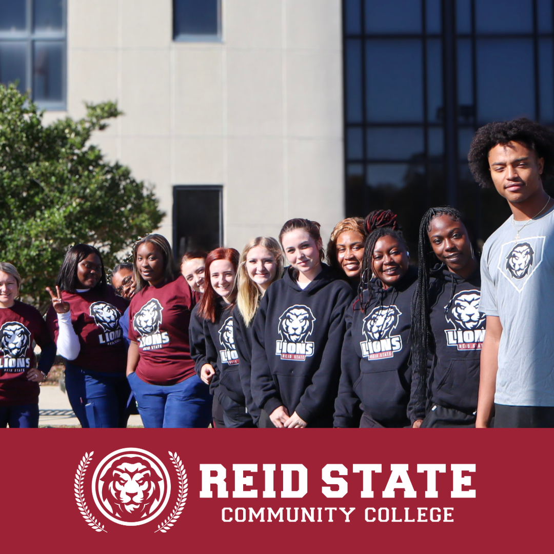 Students standing in front of Reid State Library with Lions Logo on shirts.  