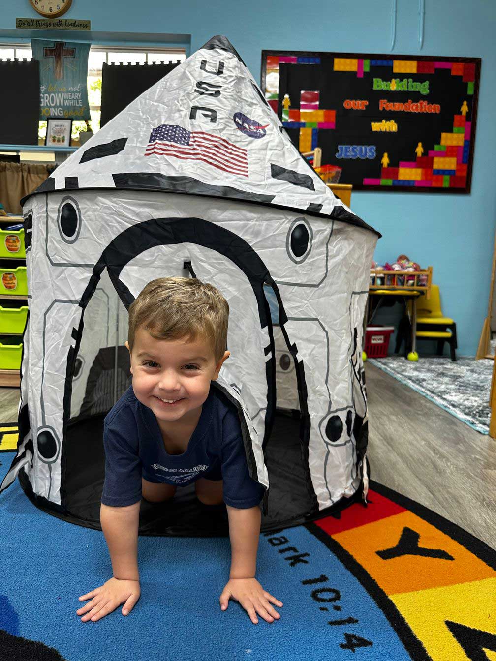 preschool boy playing space shuttle