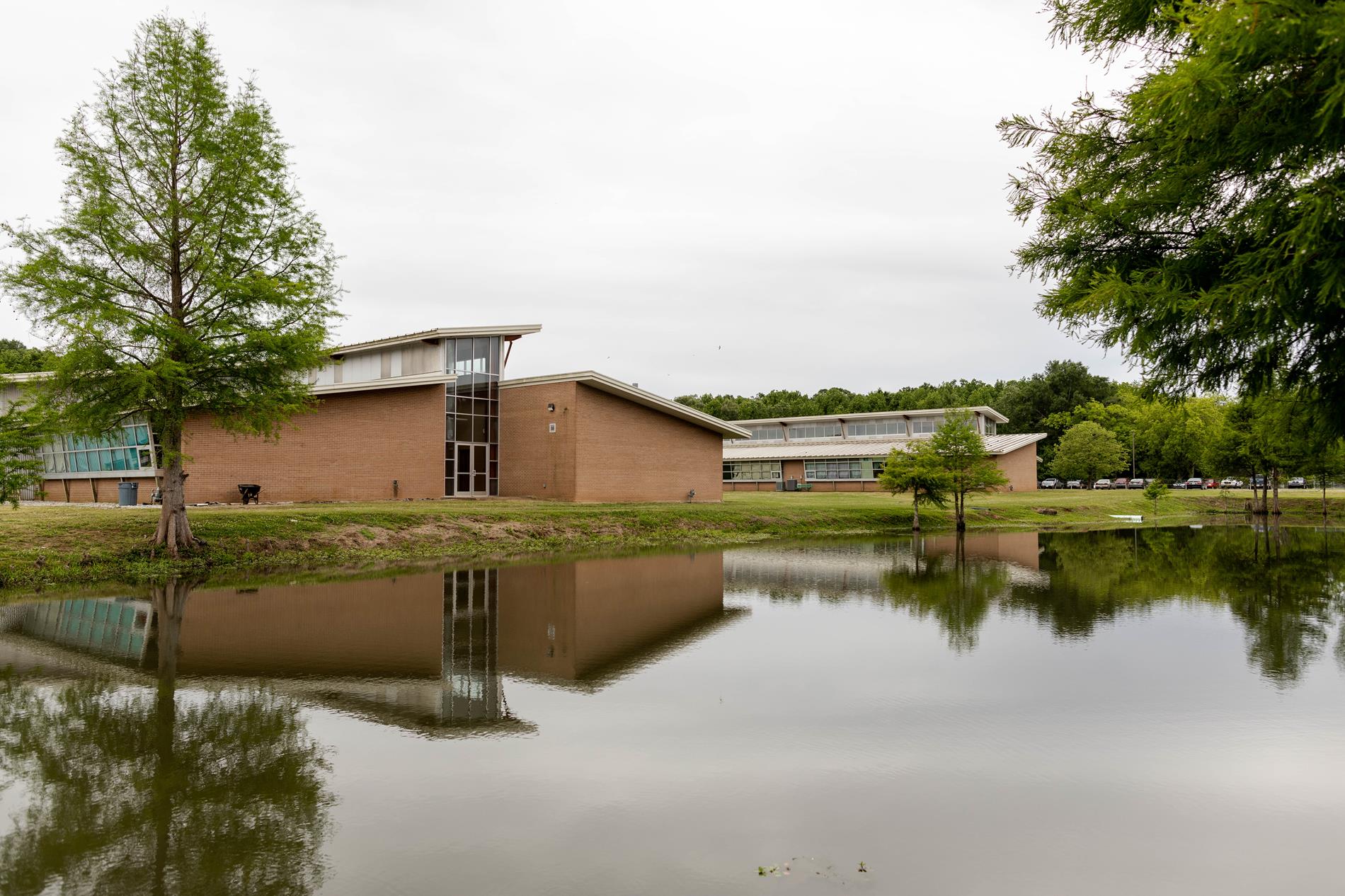School buildings by the pond
