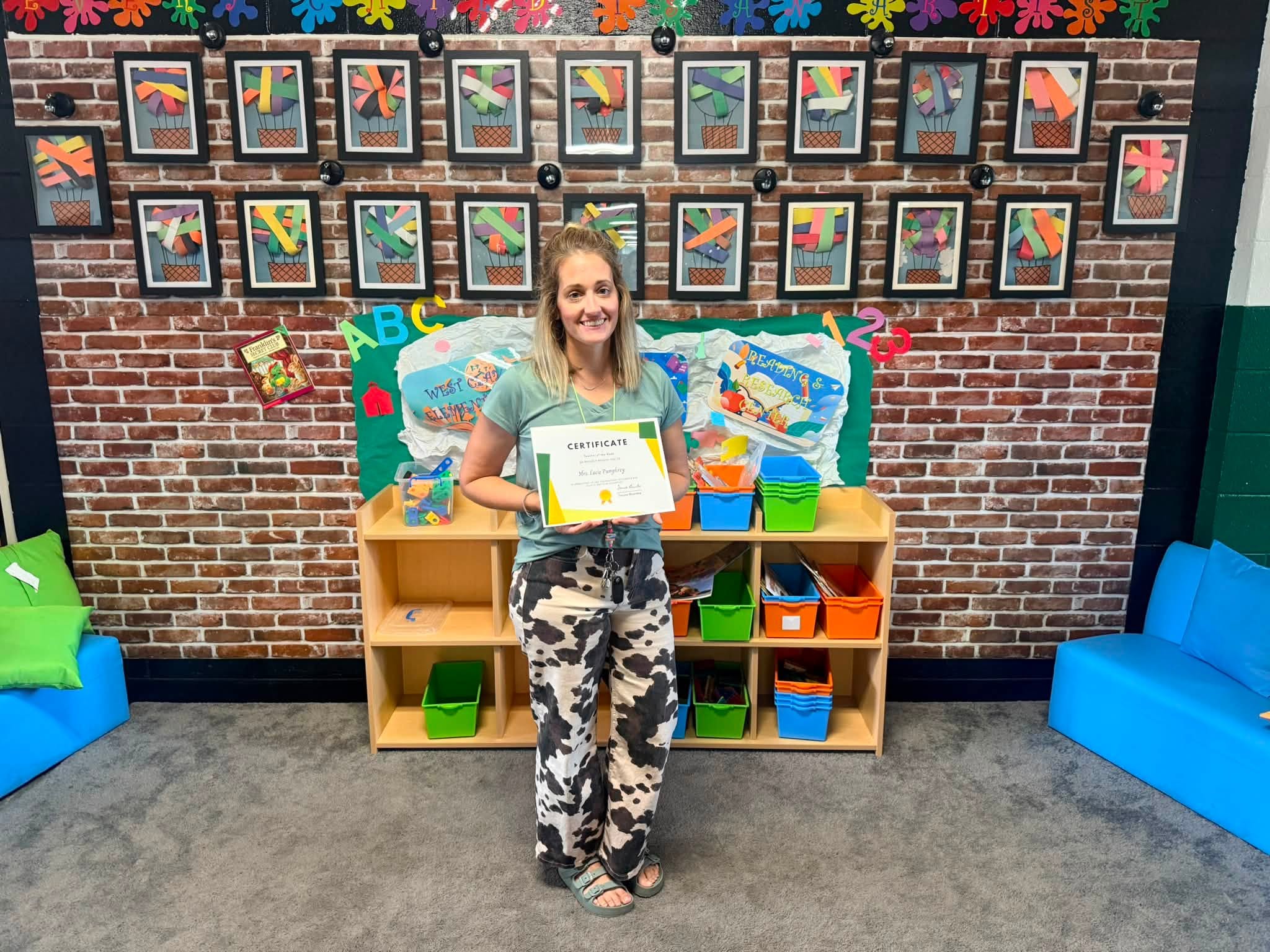 West Clay Elementary employee spotlight recipient Mrs. Lacie Pumphrey holding her recognition certificate.