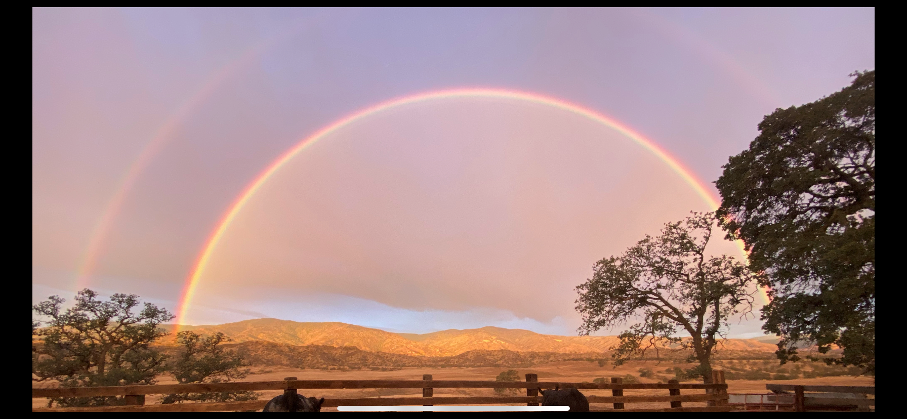 Photo By: Tristen Groteguth March 17, 2022 - Double rainbow over golden fields and mountains
