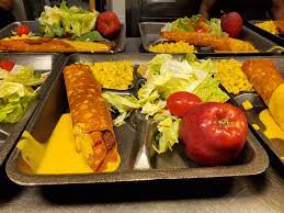 chili crispito, apple, and salad on lunch tray chili crispito, apple, and salad on lunch tray