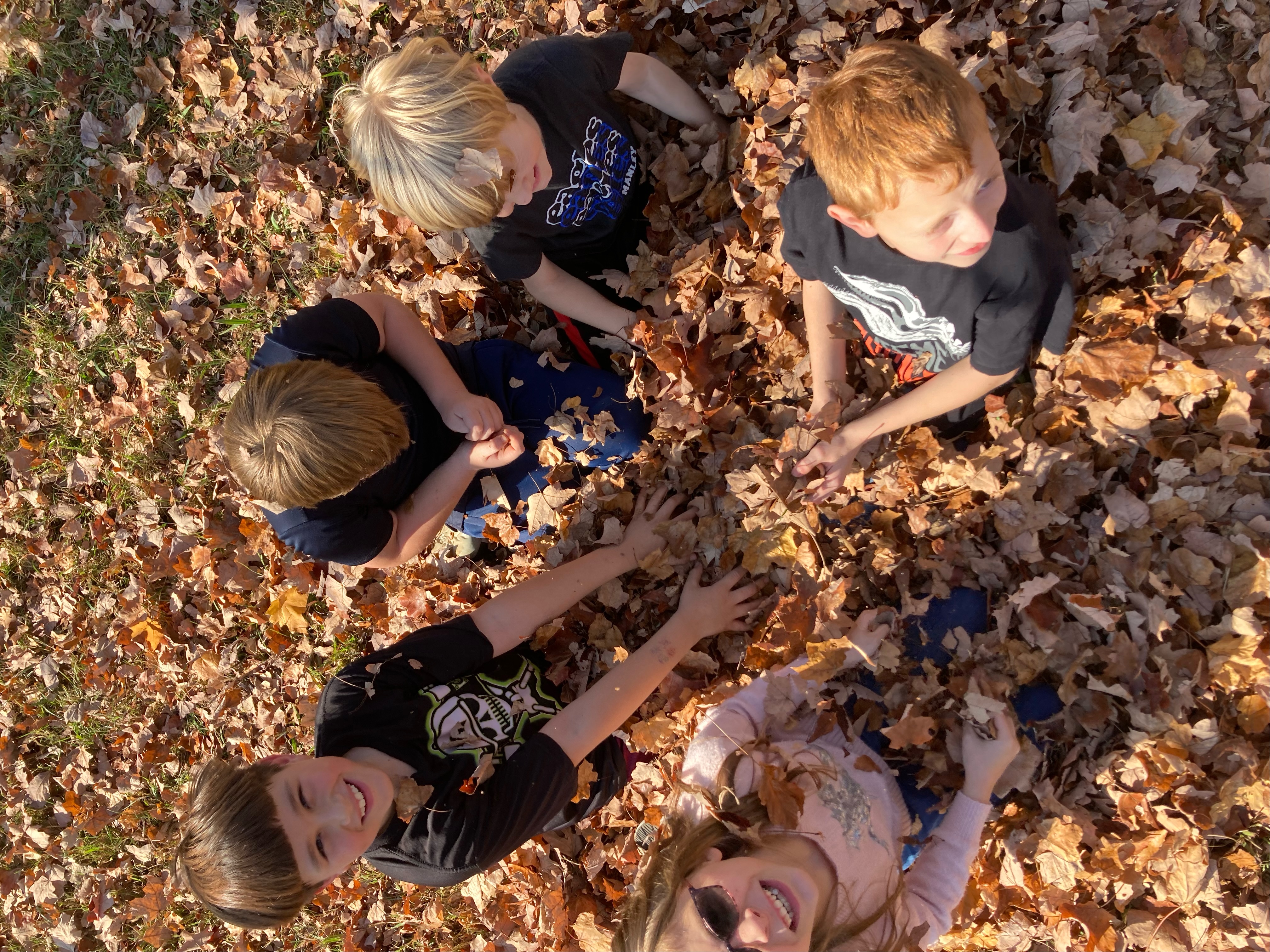 Kindergarten Students playing in leaves