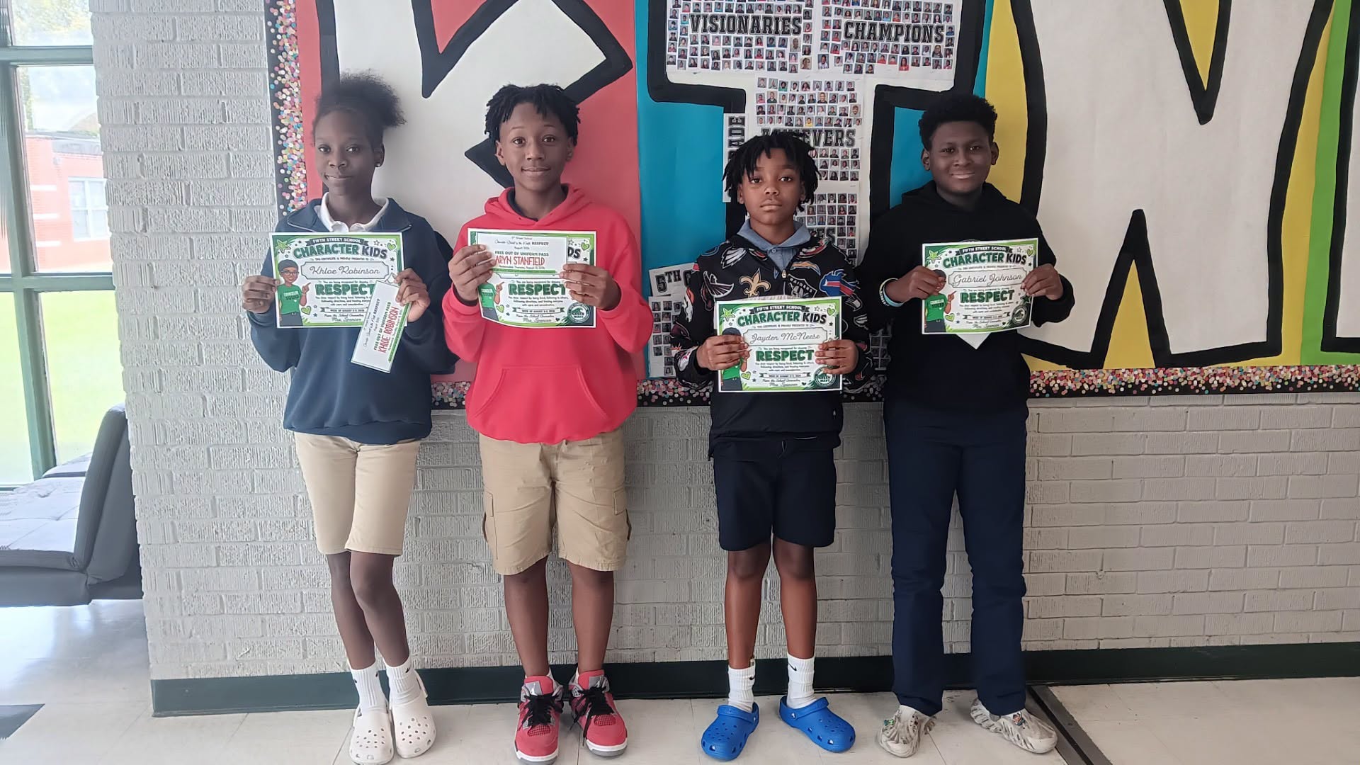 Fifth Street School students hold Character Kids certificates recognizing them for demonstrating respect.