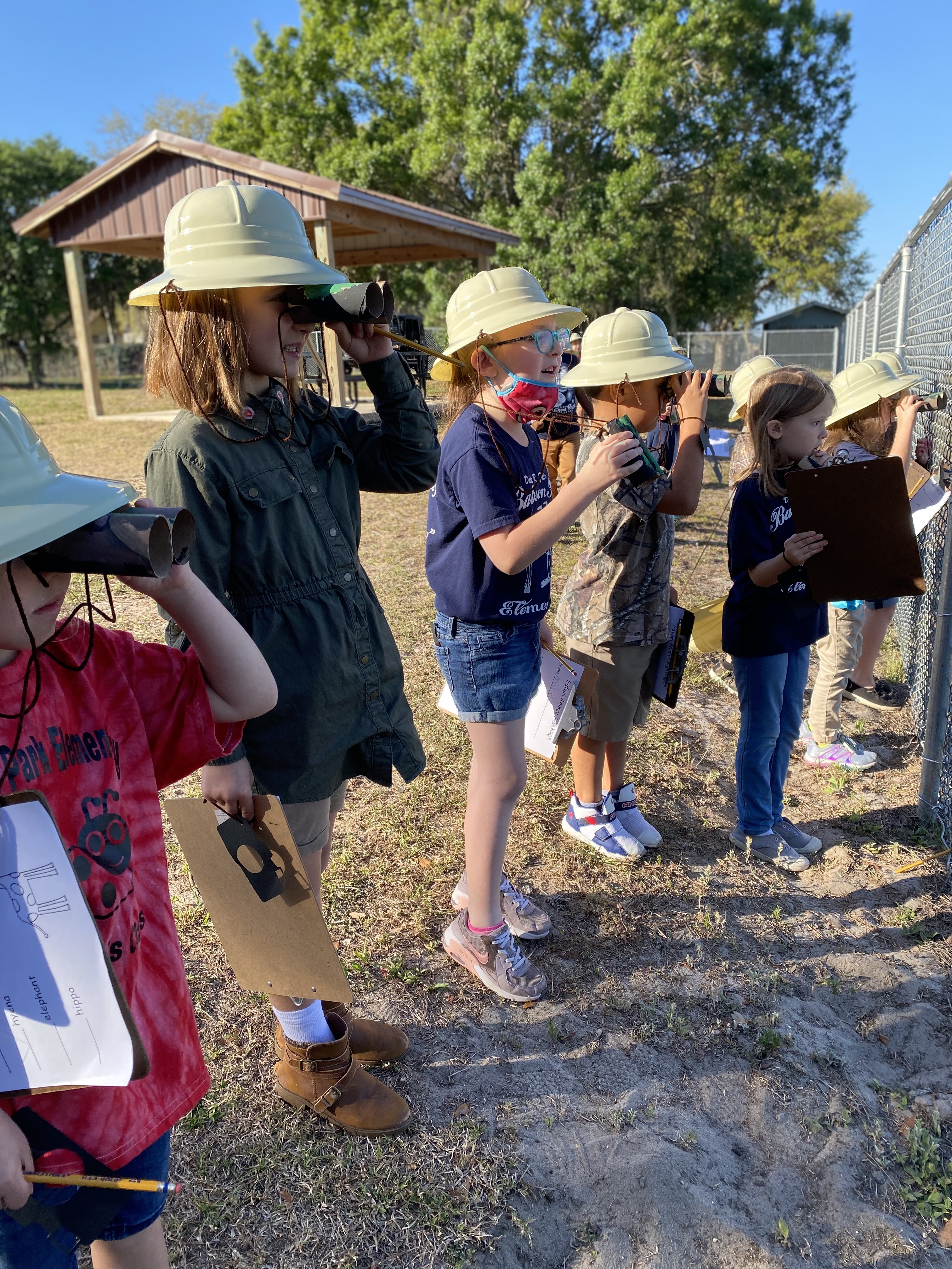 Kindergarten students looking for animals on their safari.