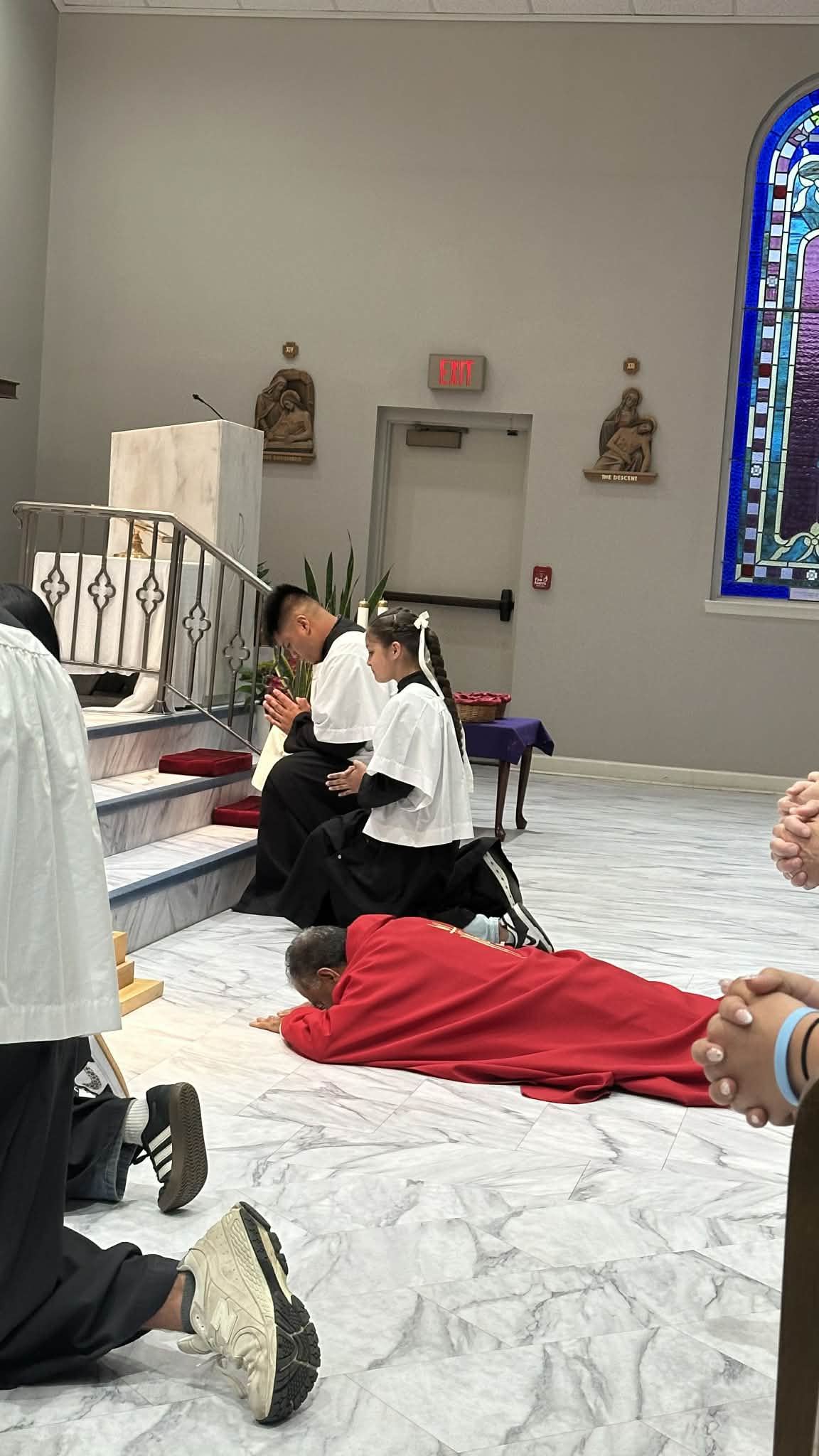 Fr. Antony prostrates before the altar while the congregation prays in silence