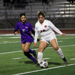 LHHS Girls soccer tries to block opponent moving the ball downfield