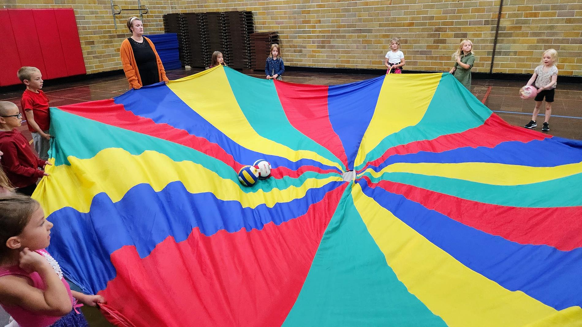 Children's House playing with a giant Parachute