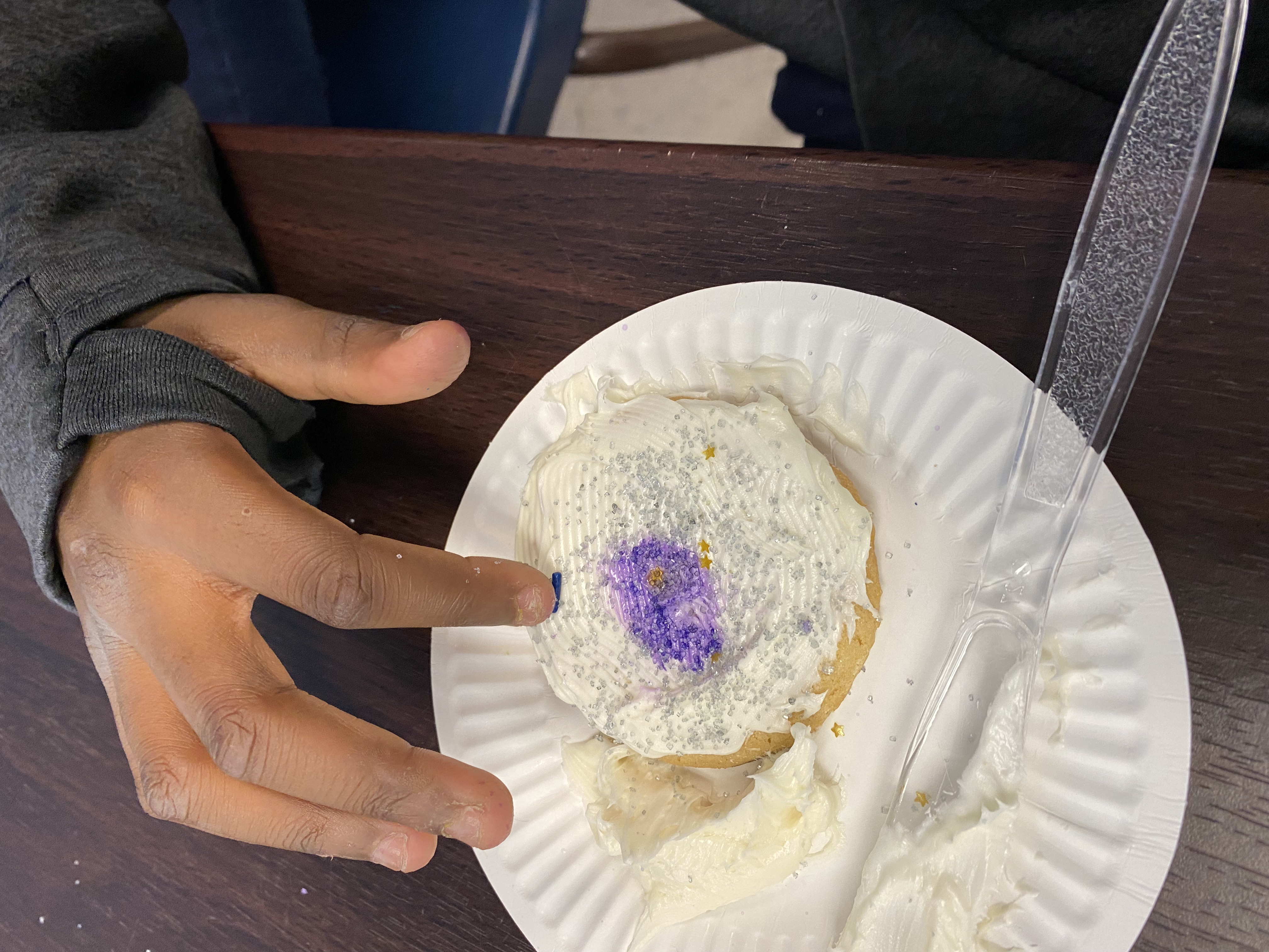 A student adding our solar system to their galaxy cookie. 