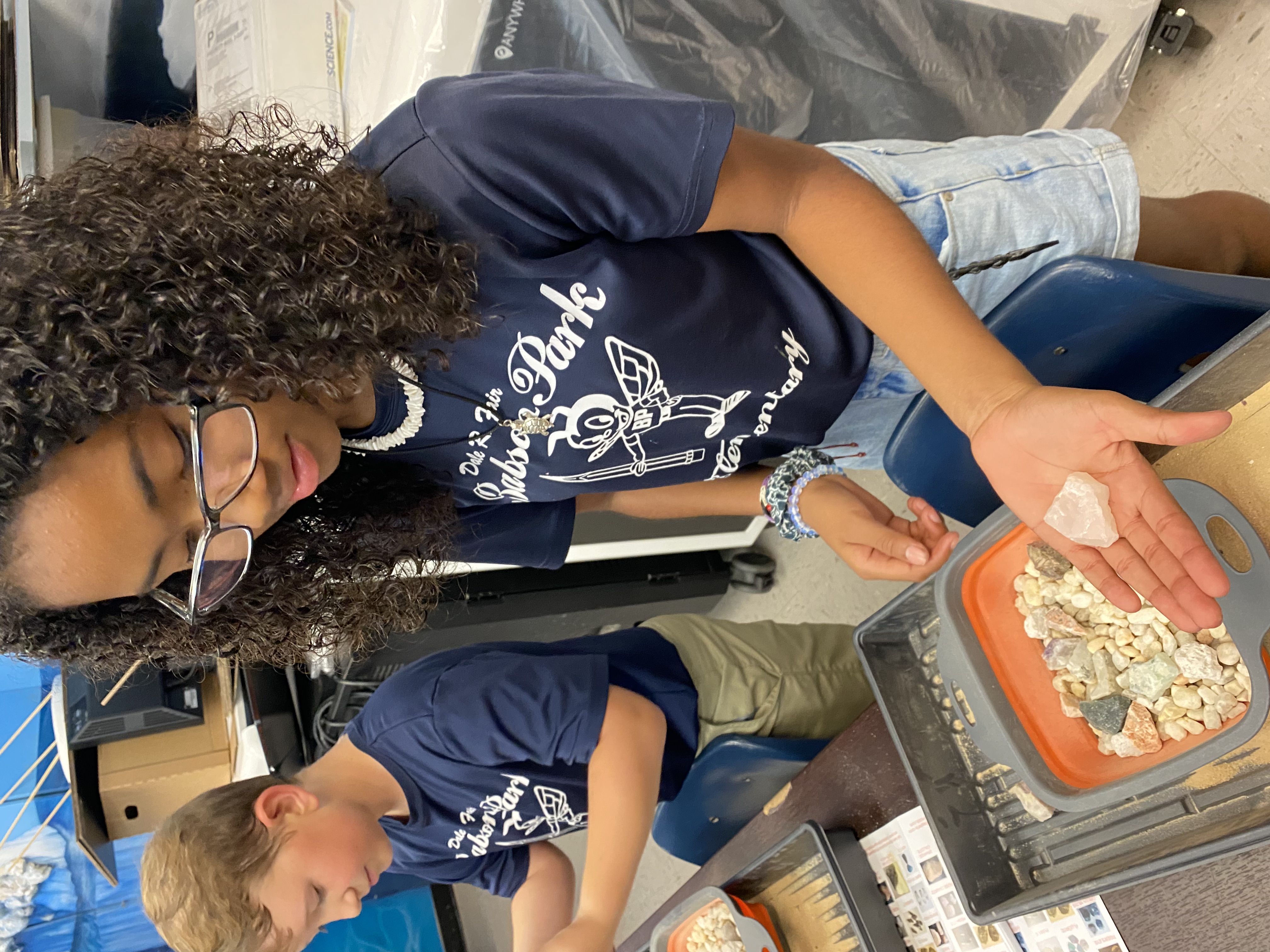 One of students excited to show off their findings from their mining for rocks and minerals.