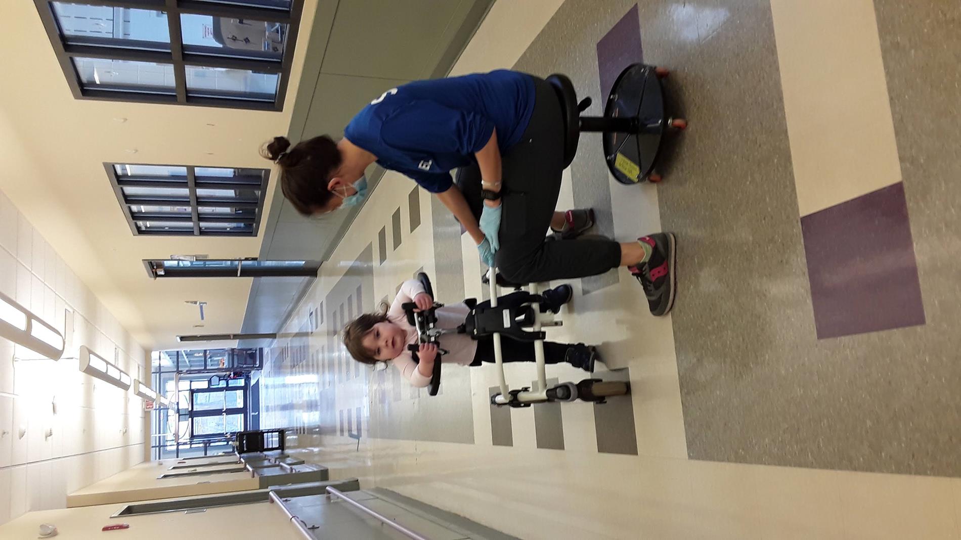 student in gait trainer with PT