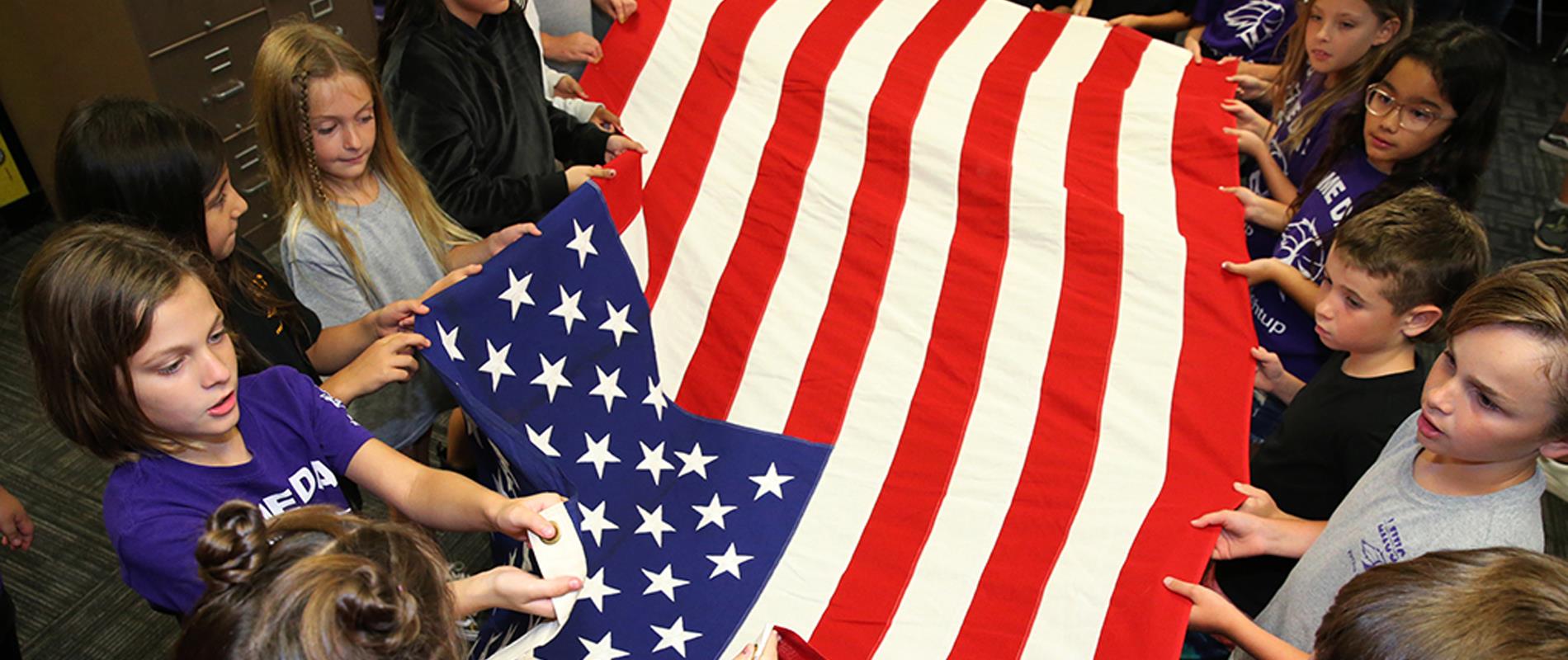 students learn to fold the American Flag