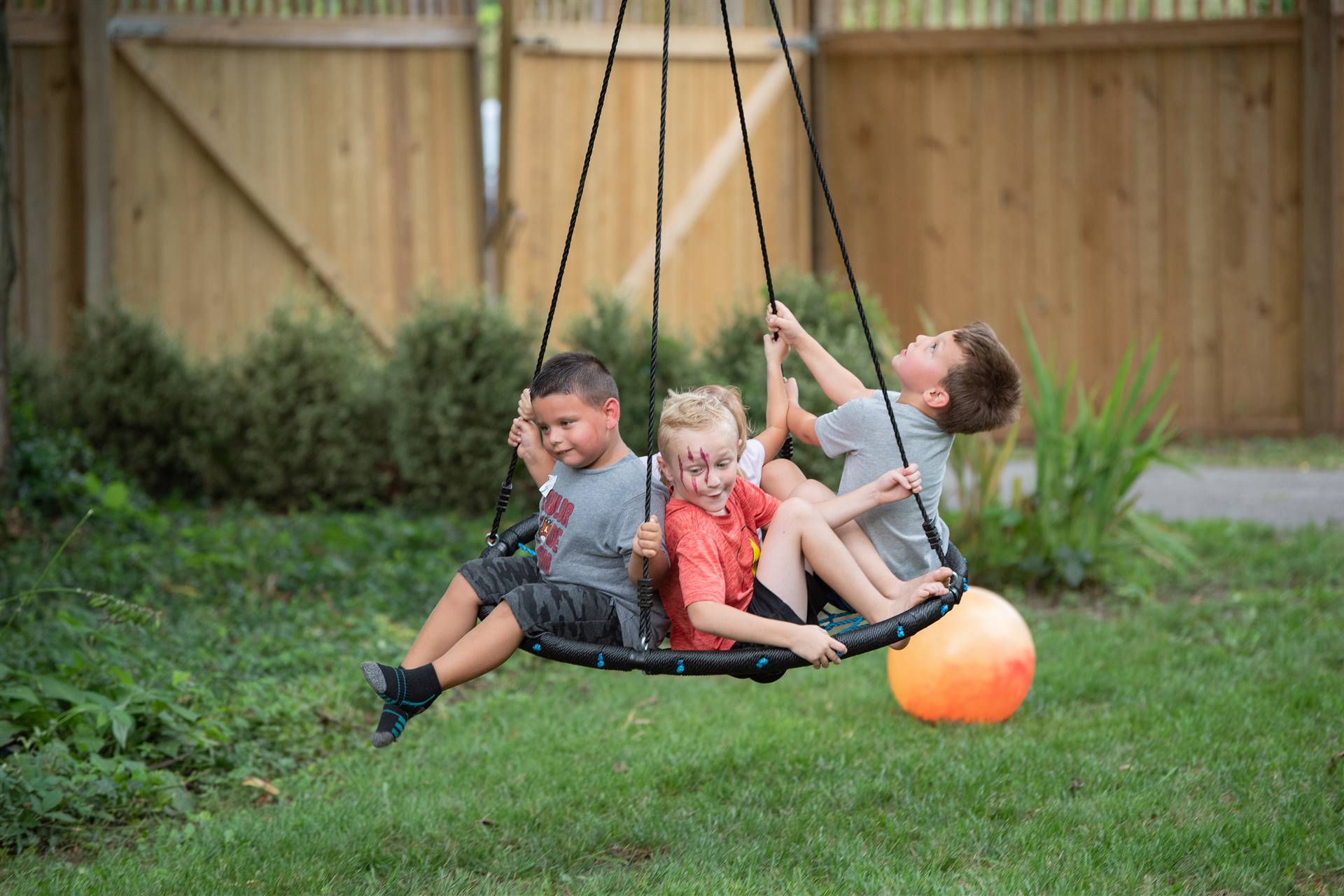 3 boys on swing