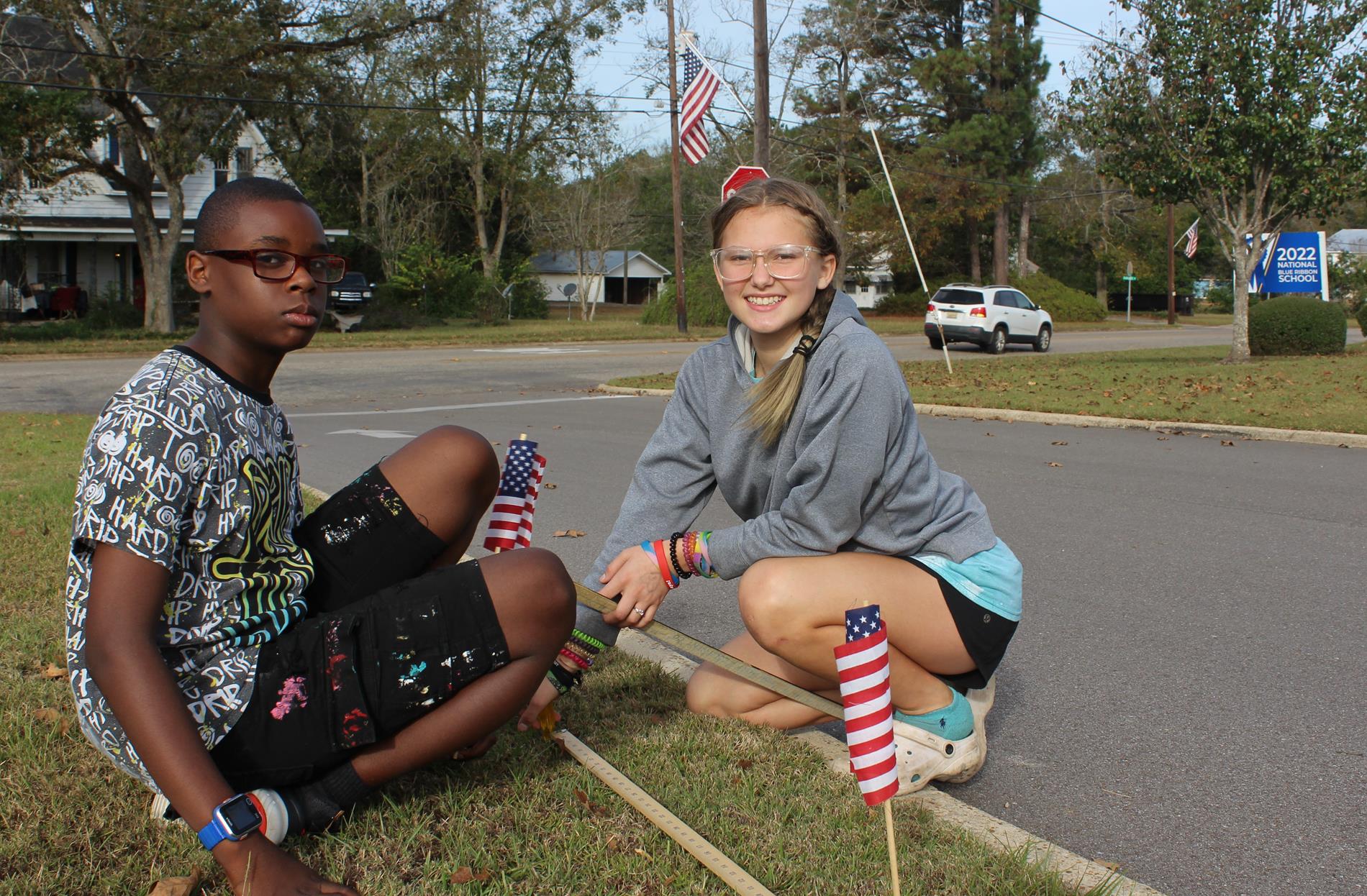 Peer Helper members decorating our bus lane with flags in honor of Veterans Day.