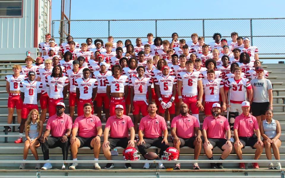 Bunkie High School football team in white jerseys with coaches
