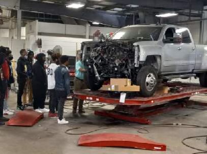 Collision Repair Students viewing the body work at Capitol Body Shop