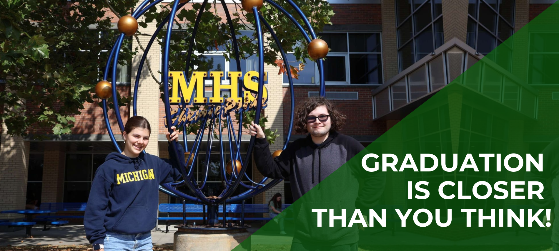 Graduation is closer than you think over 2 students standing outside of a school 