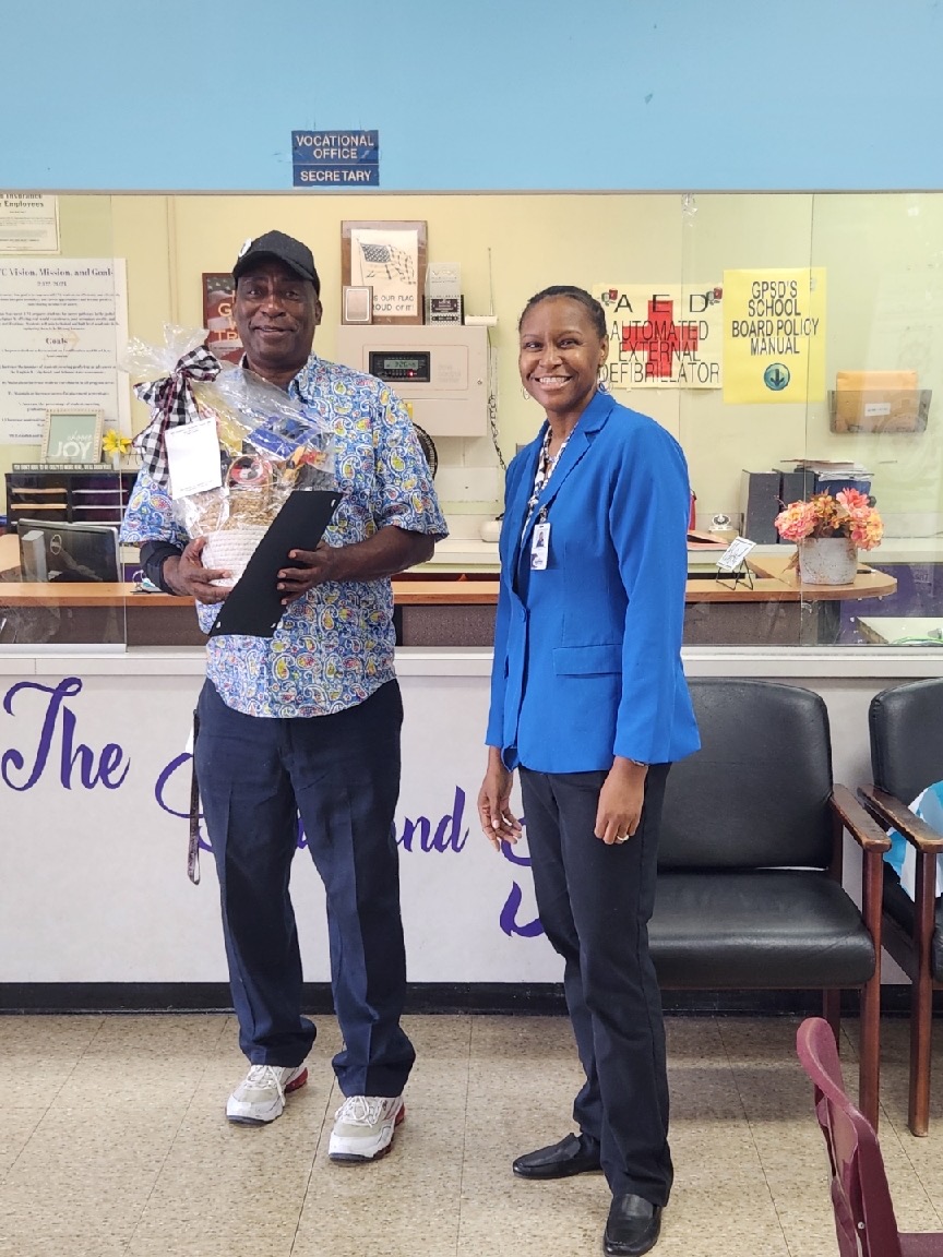 Dr. Kandice Jernigan presents Mr. Henry Joiner a basket from the GTC Staff for National Custodian Day 2023.