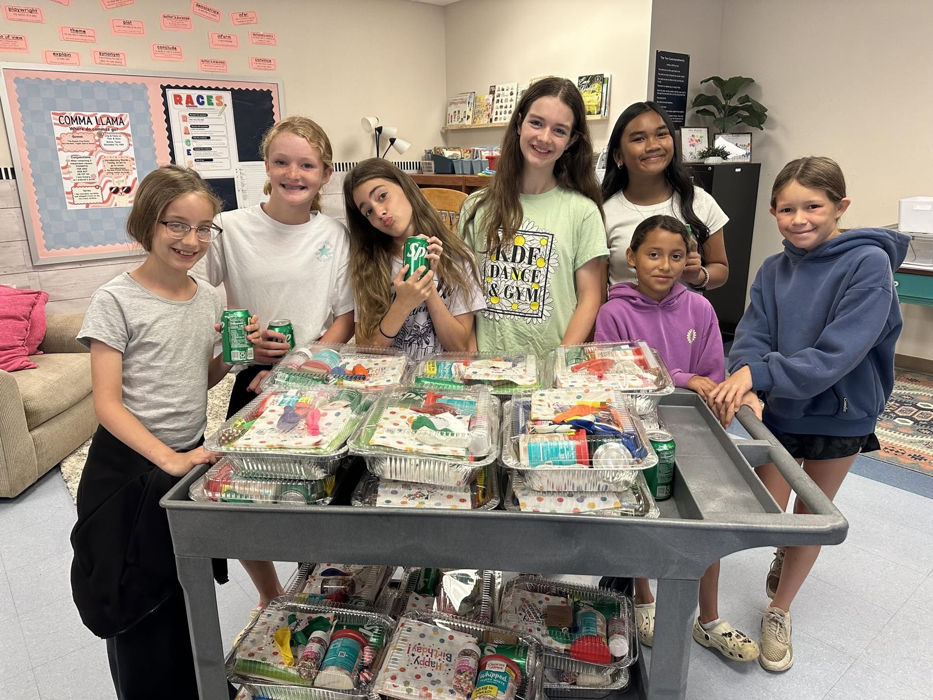Students with birthday cake boxes