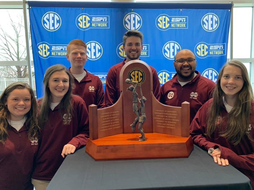MSU Band Members with women's sec basketball championship trophy