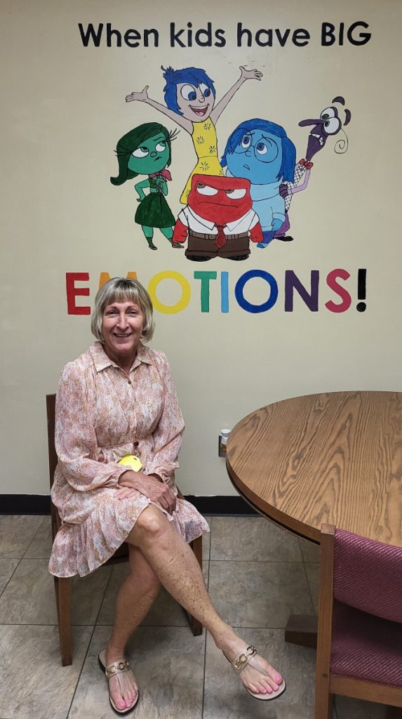 Mrs. Gutzwiller sitting in a chair in her office 