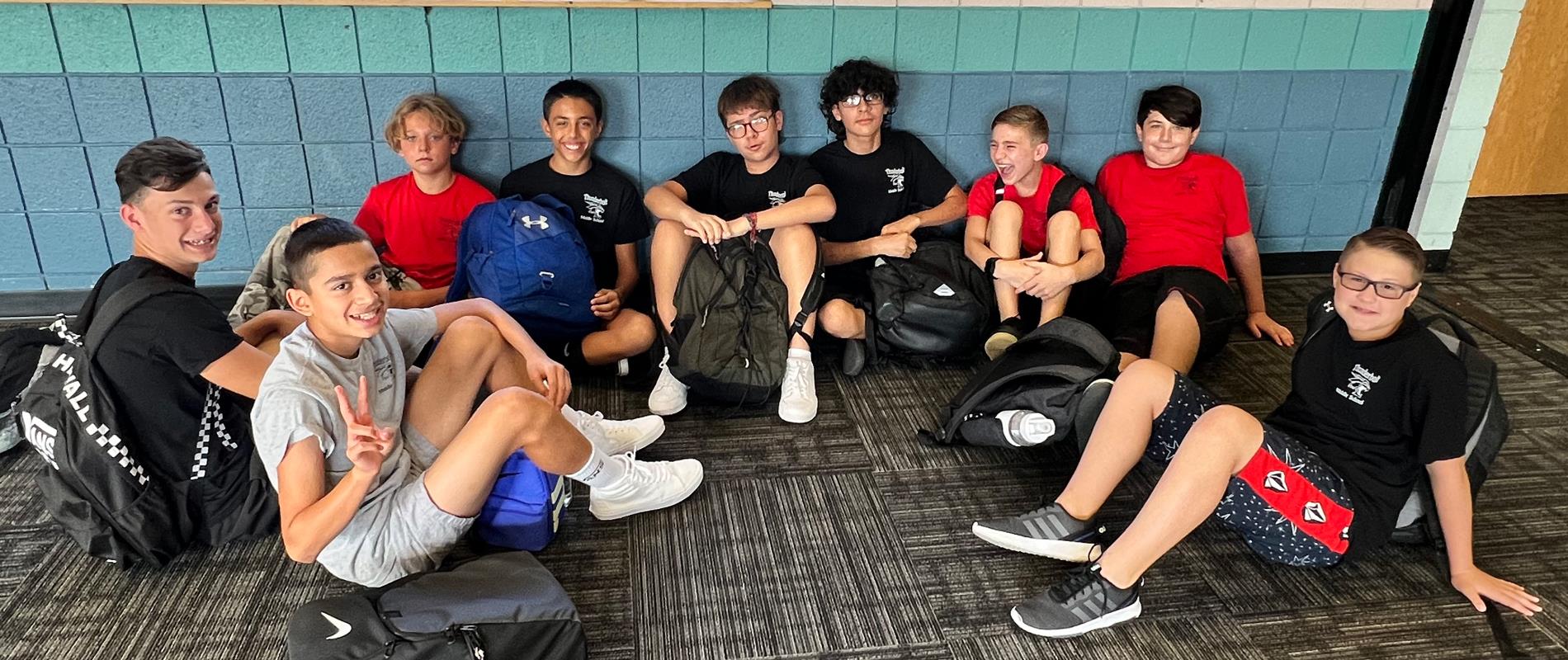 Group of boys sitting in the hallway