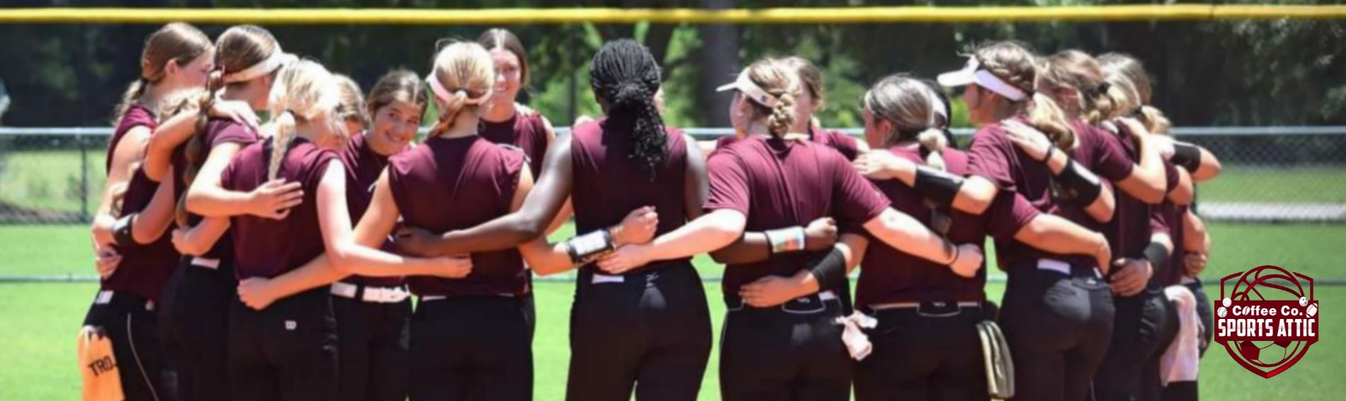 Coffee High Softball Players in a huddle celebrating a win!