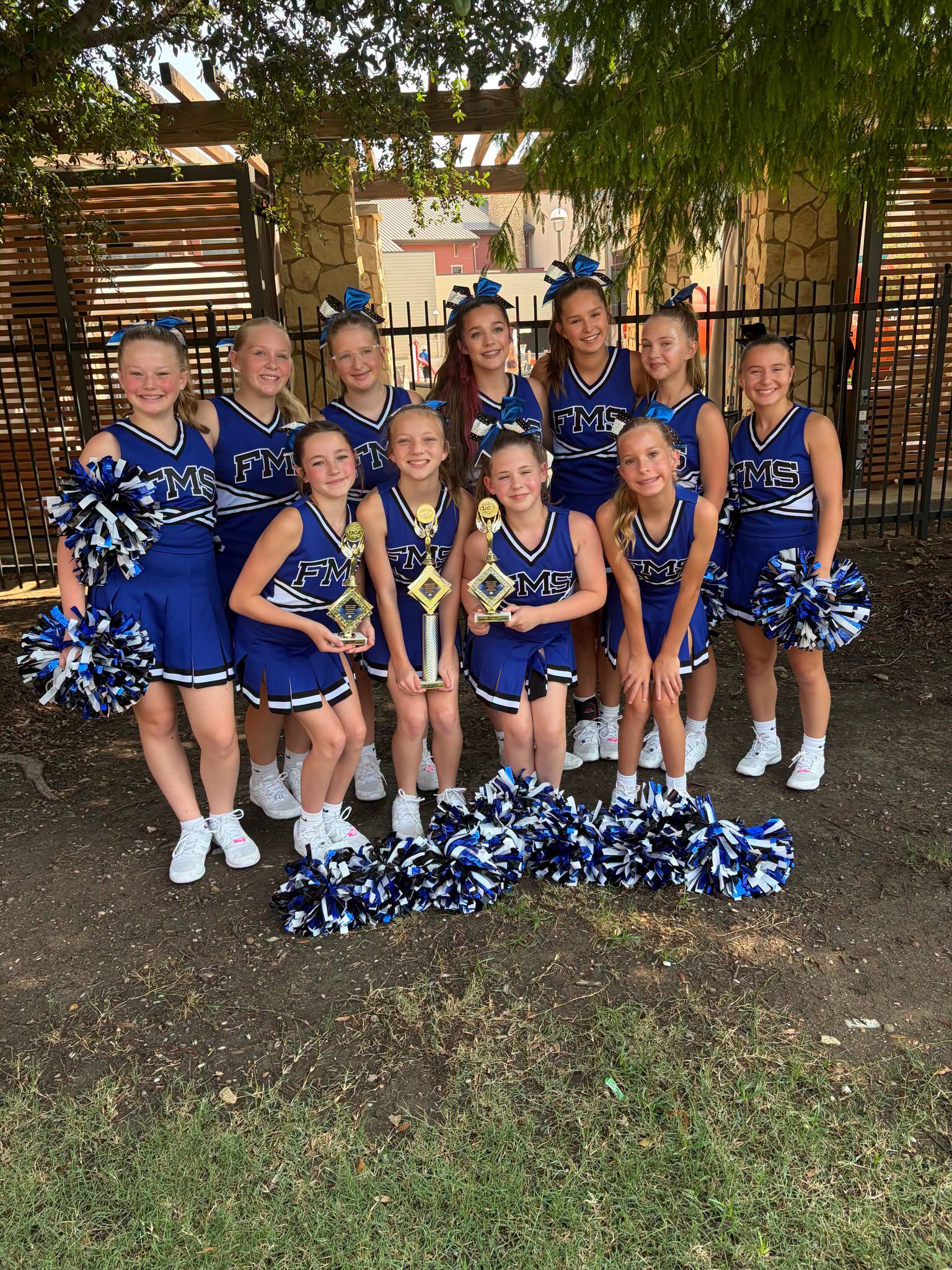 middle school cheerleaders pose together
