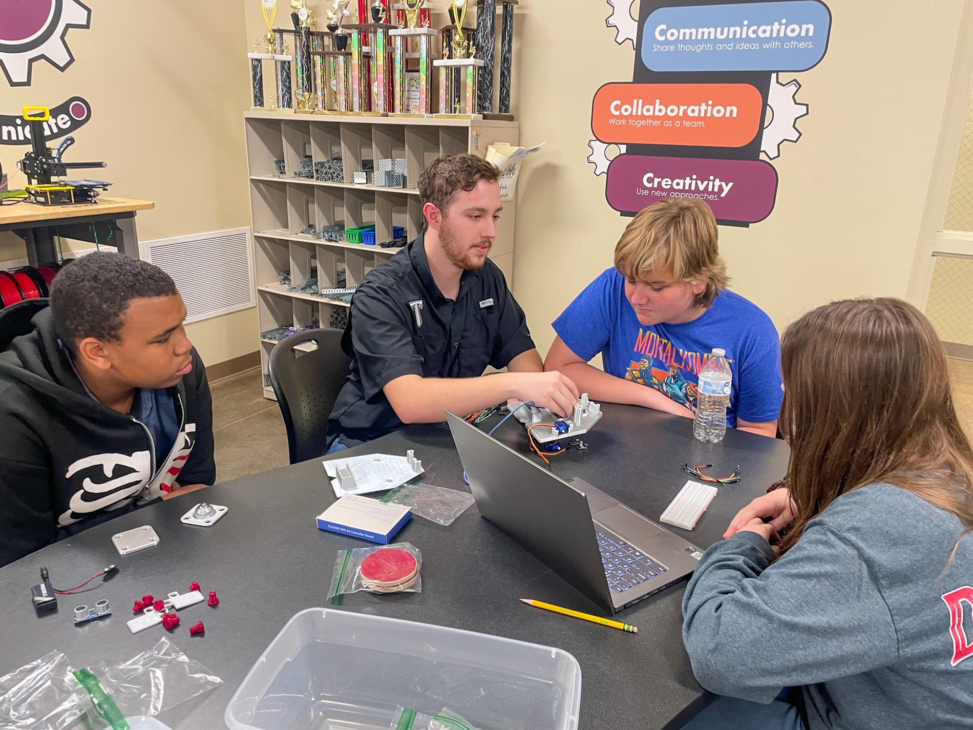 Troy University Electrical Engineering students help 8th-grade STEM students.