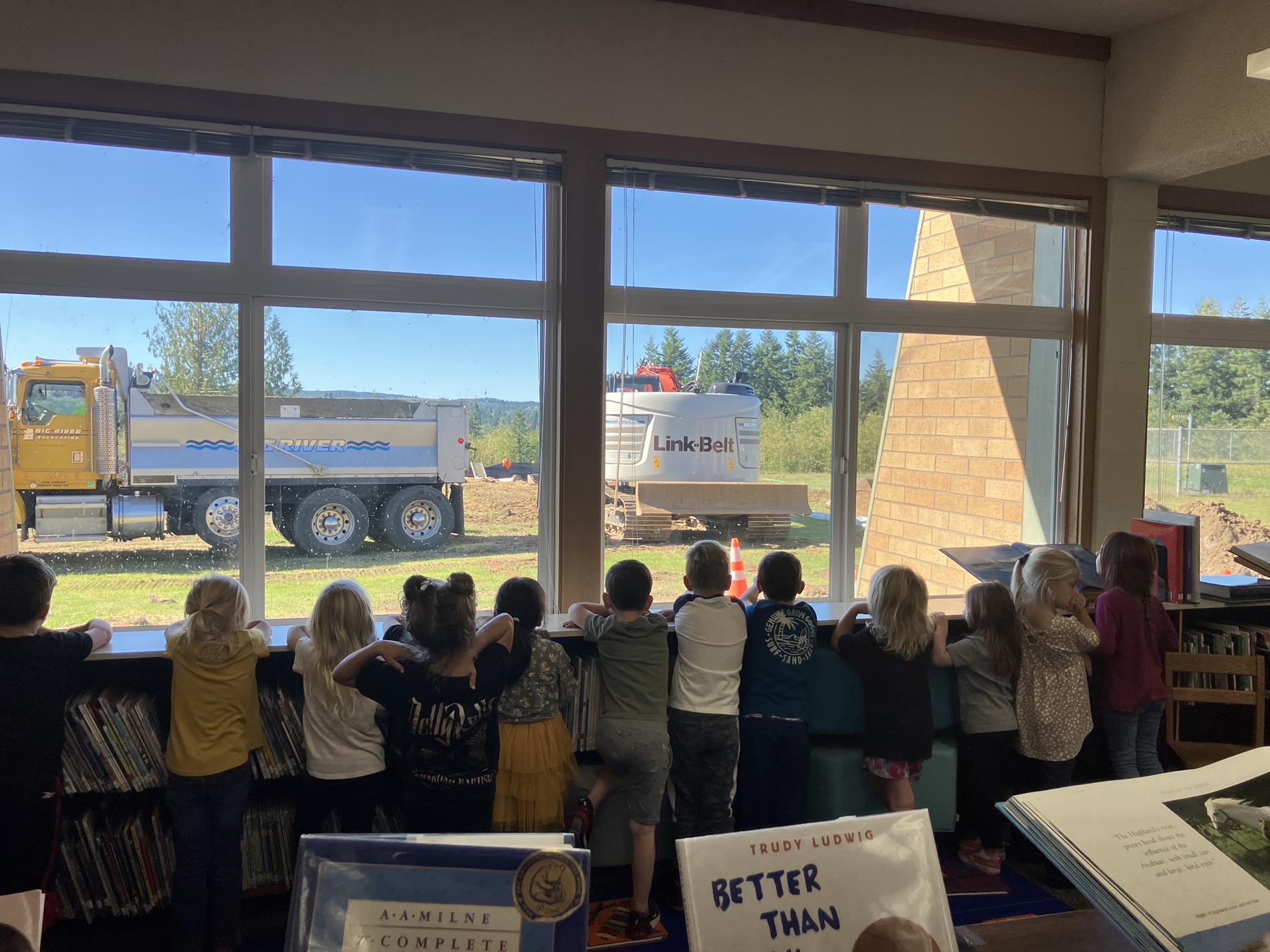 HLE Kids watching Big River work on our new Gym and Playground. 