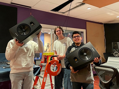 students in Music/Audio class setting up new speakers