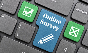 laptop keyboard with enter key saying Online Survey