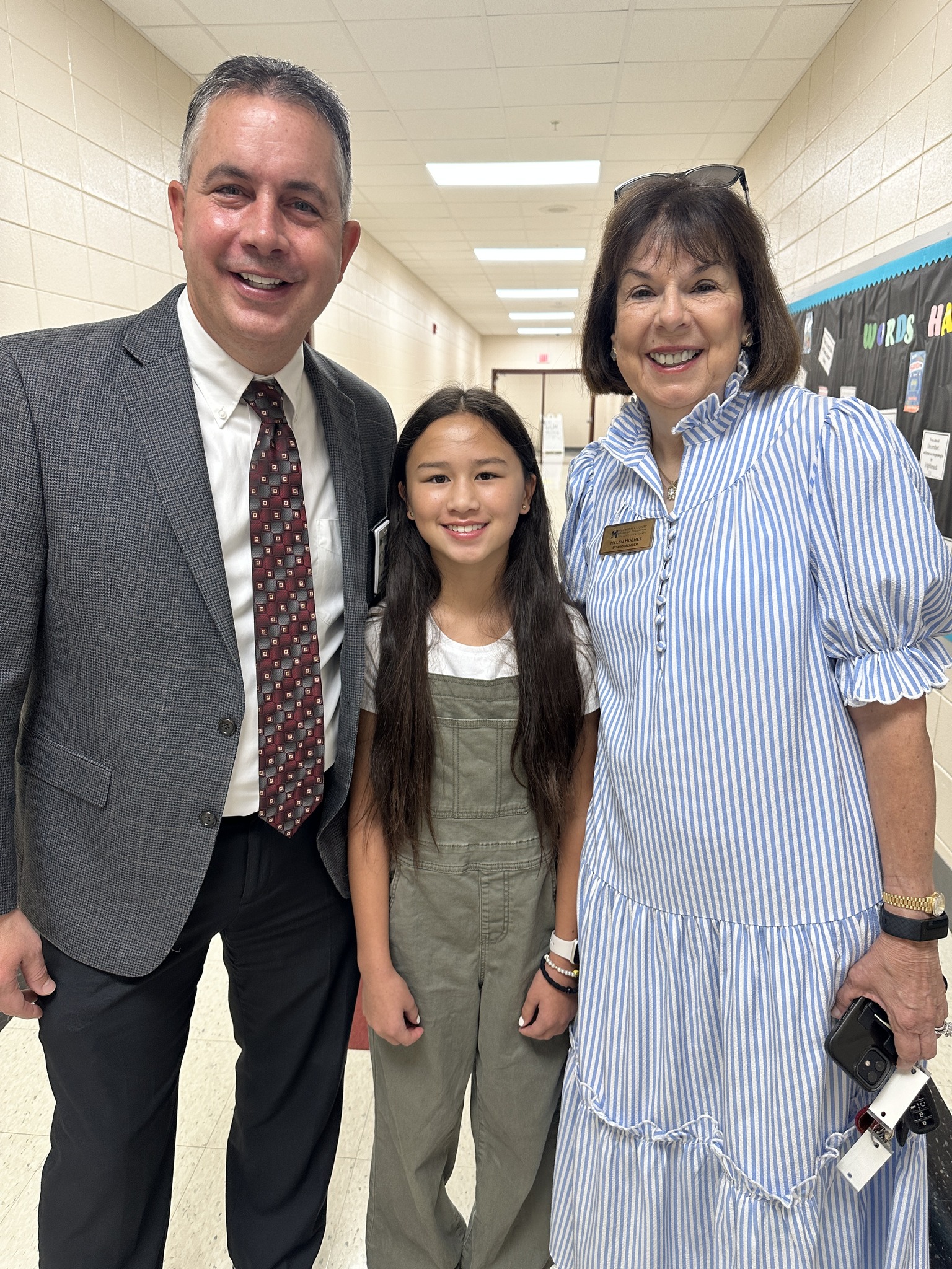 Dr. Rogers with a student and Helen Hughes, Board Chair