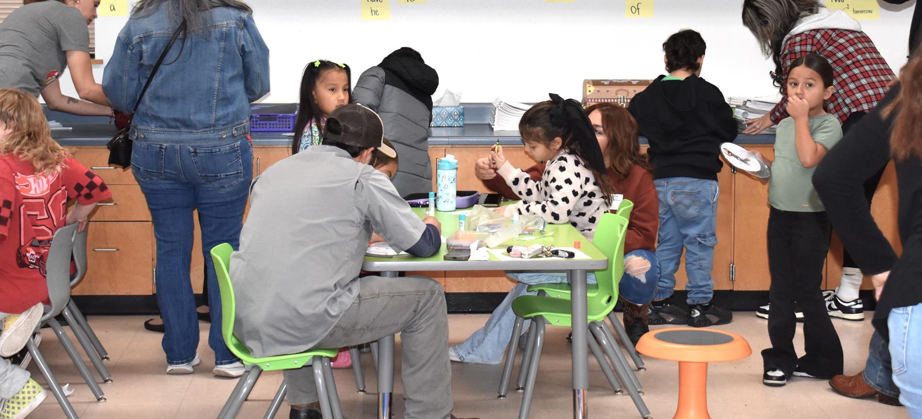 Parents and students working snow globe project
