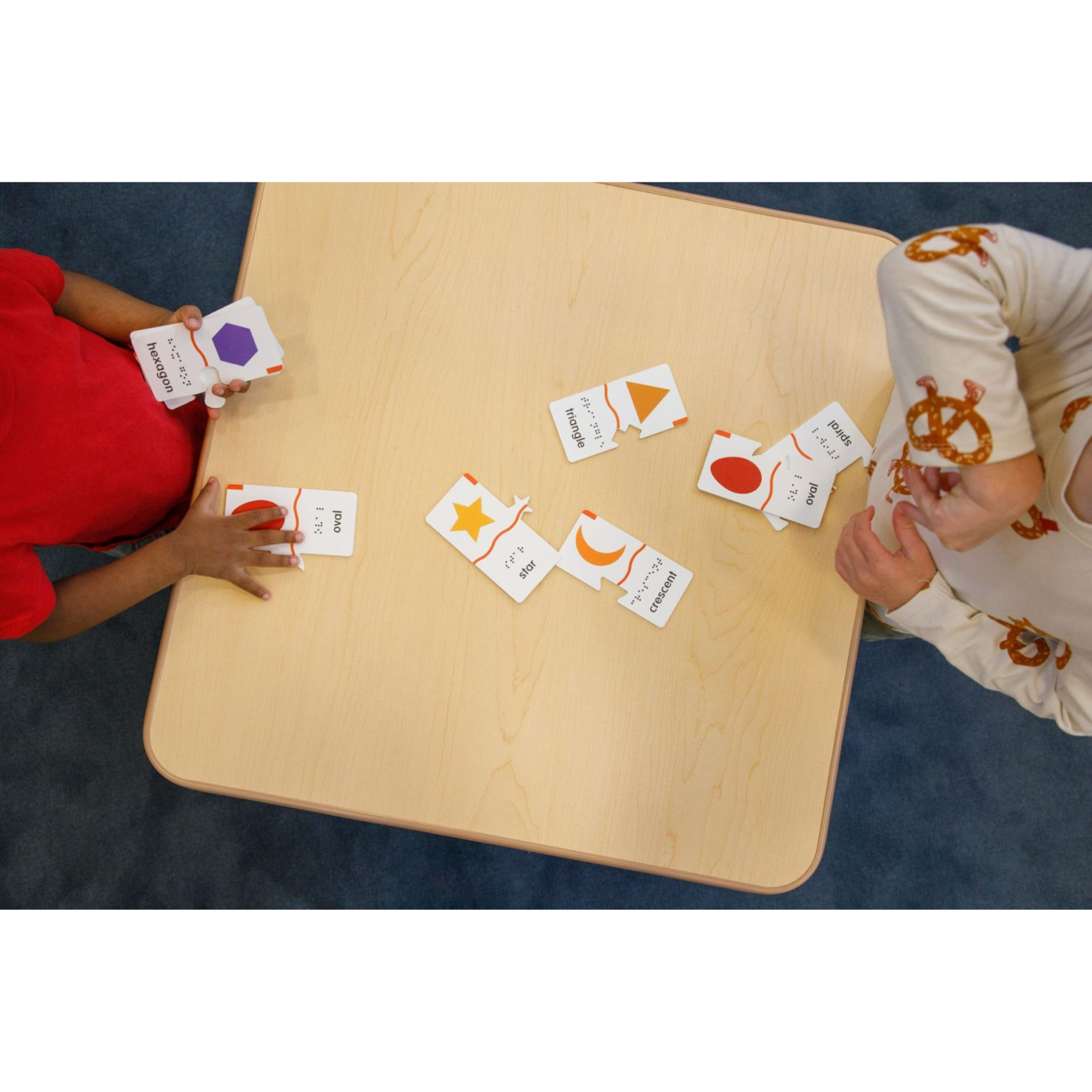 kids playing memory puzzle shapes on table