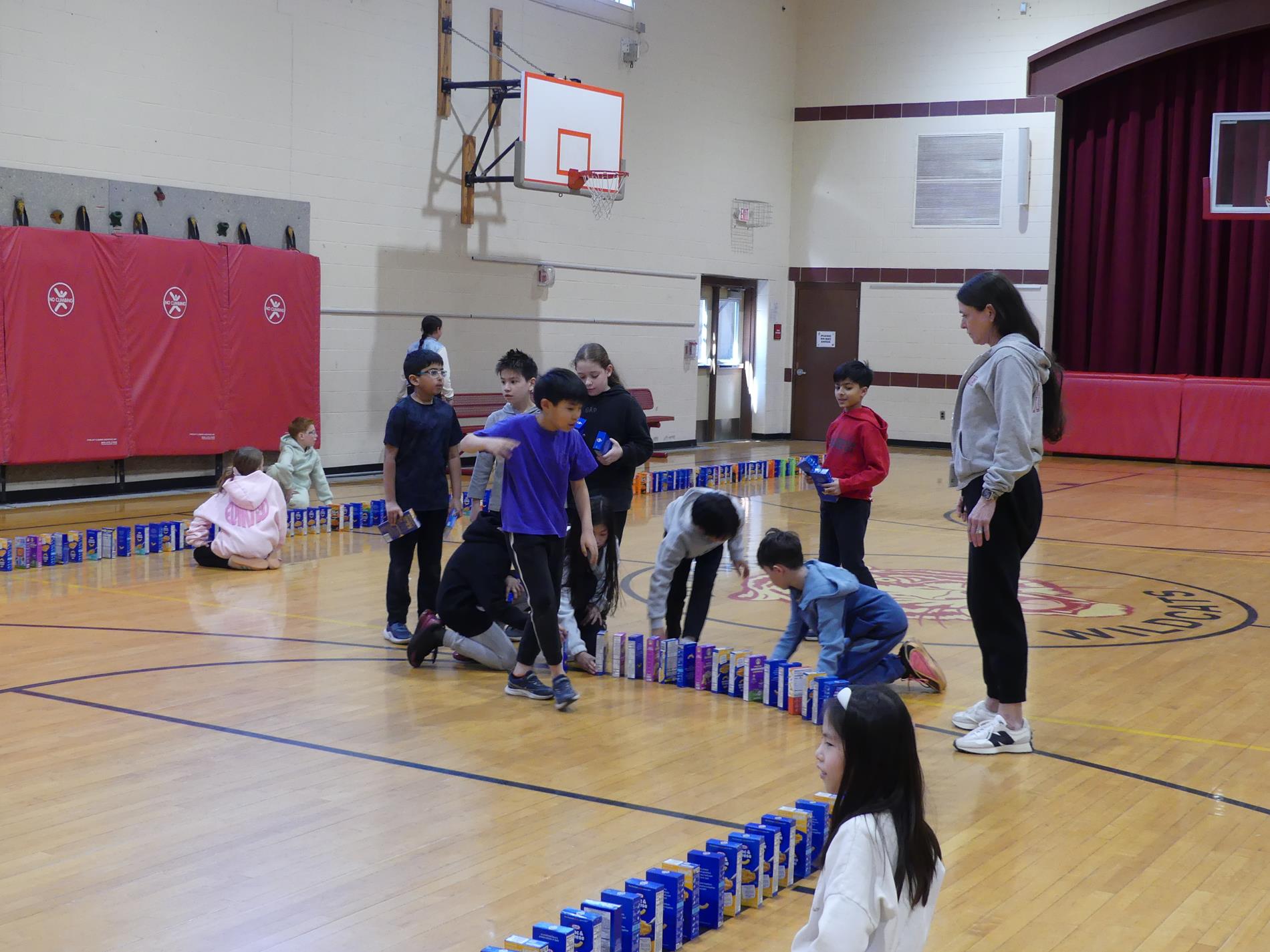 Macaroni & Cheese collection shows students and boxes set up like dominos