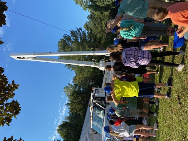 students in front of bucket truck