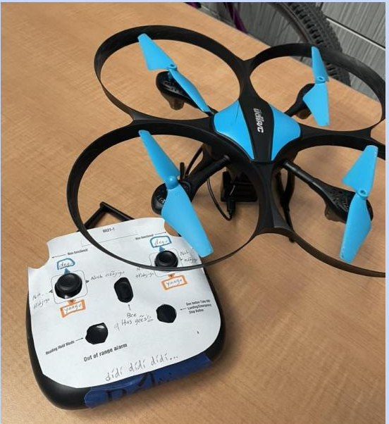 A blue quadcopter drone beside a controller hand-labeled in Diné Bizaad.