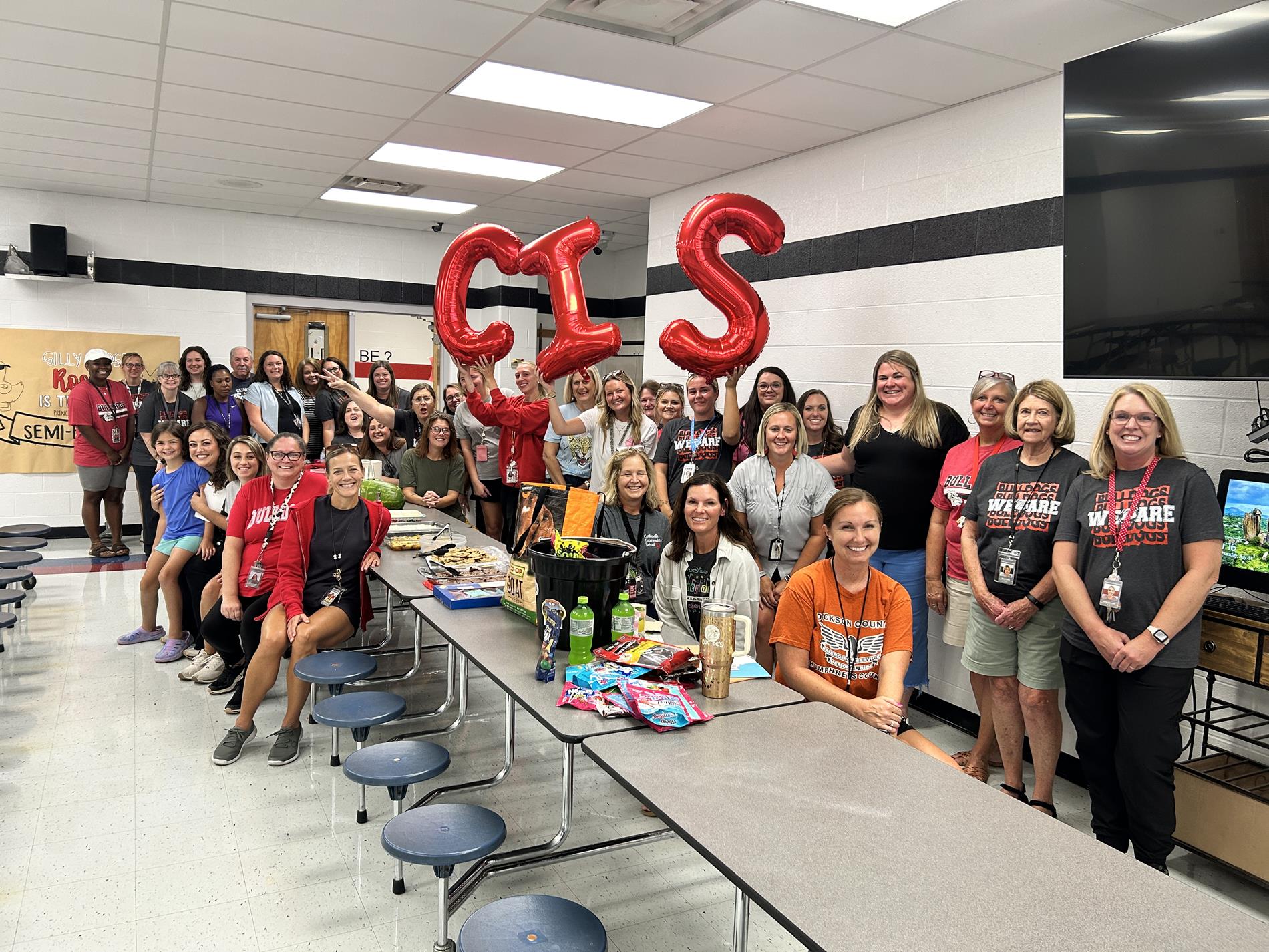 CIS Teachers posing for a picture in their cafeteria