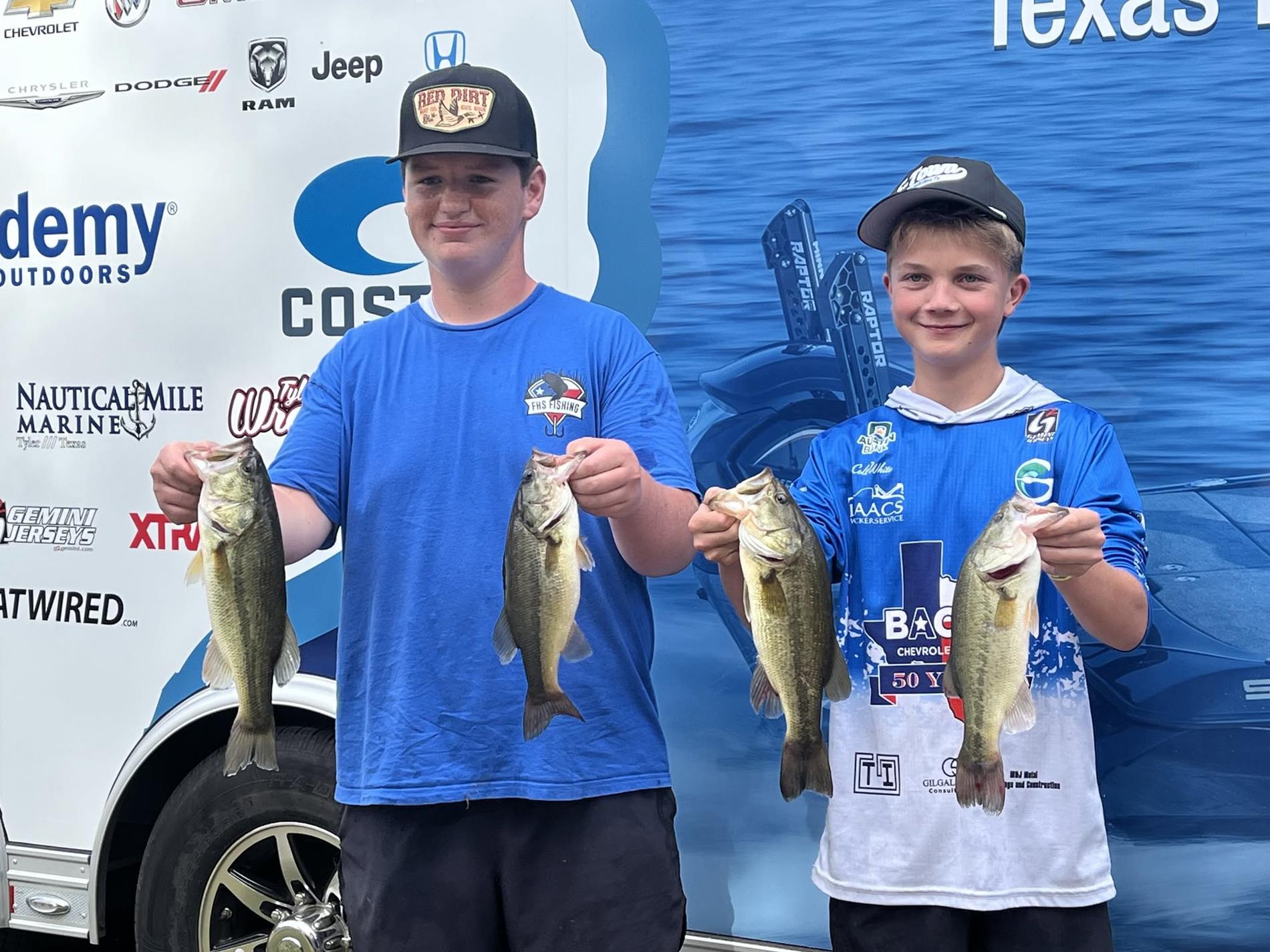 2 members of the fishing team posing with 4 fish