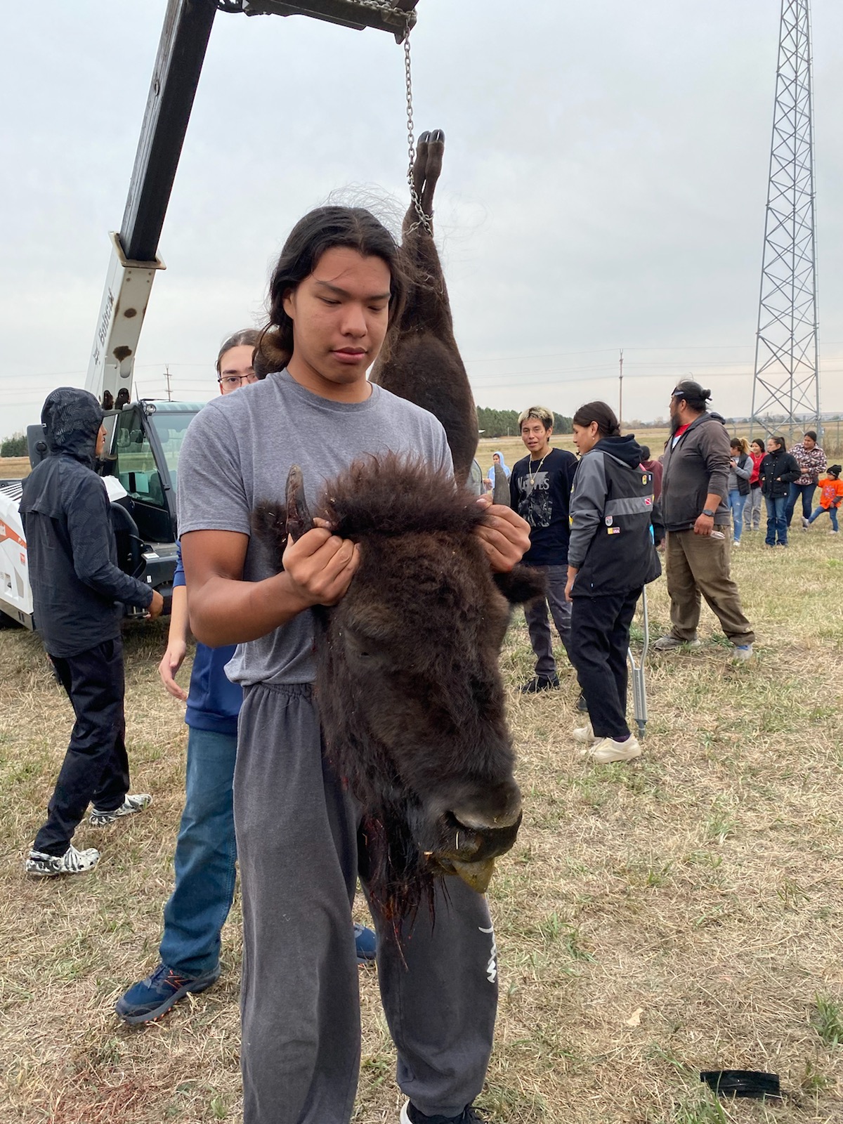 Student with hide of buffalo head