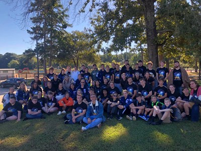 band sitting on ground at competition