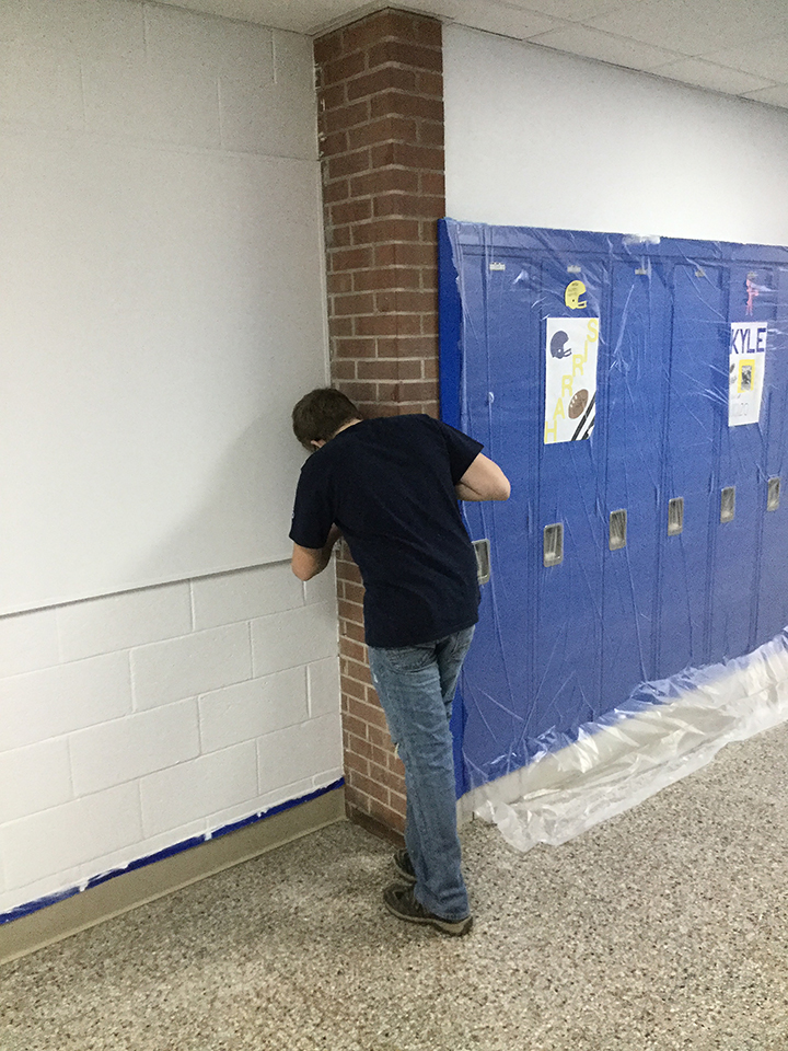 Students volunteering to help paint
