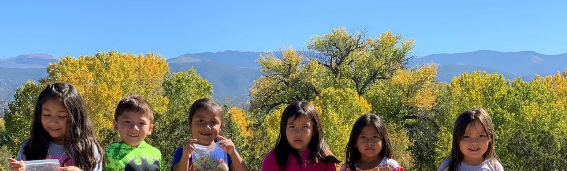 young children in front of mountain